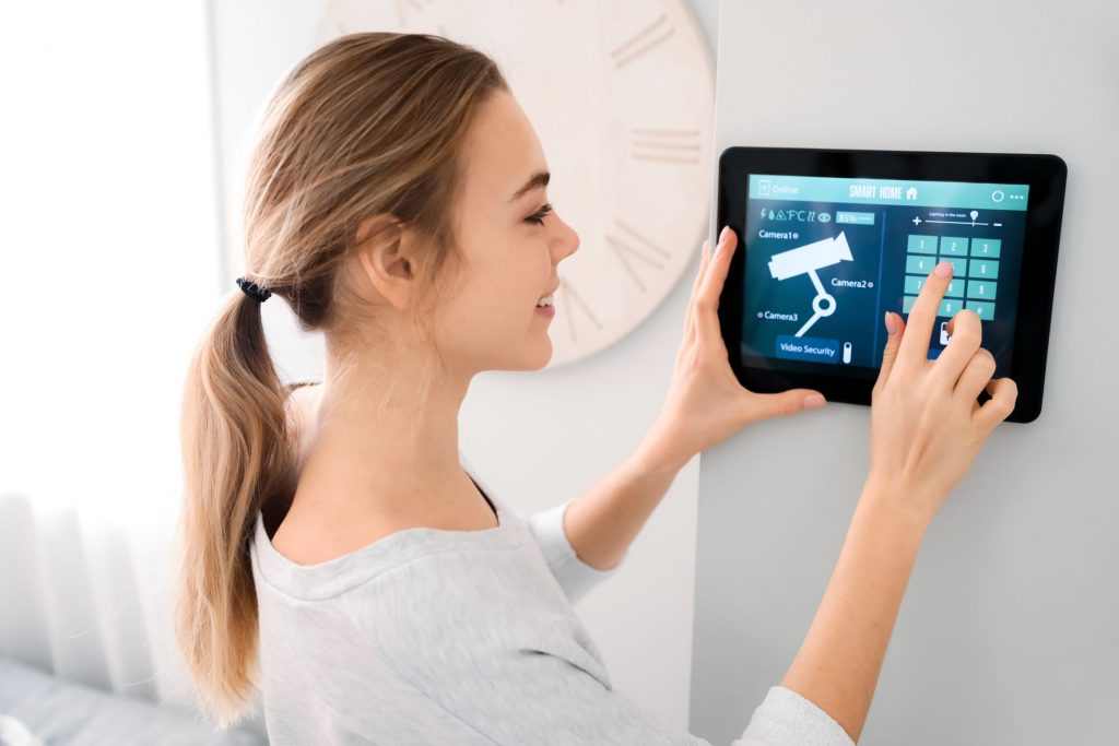 woman checking the security features of smart home